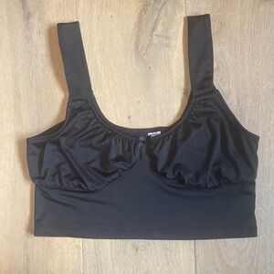 Black cropped divided tank top with a small bow in the front